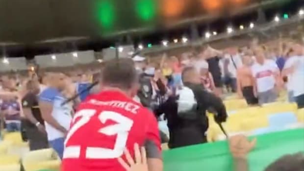 Goalkeeper Emiliano Martinez pictured trying to slap a baton from an officer's hand after witnessing clashes between police and Argentina fans at Brazil's Estadio do Maracana in November 2023